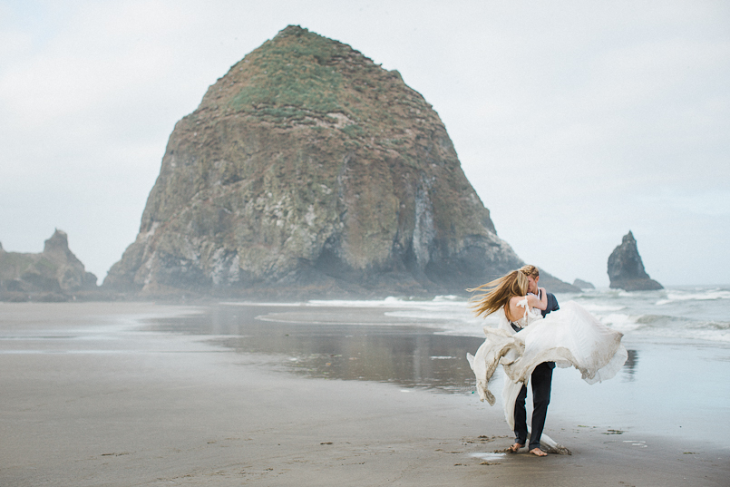 groom carries bride at cannon beach elopement 