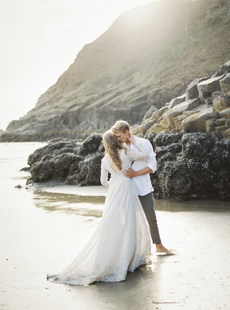 bride and groom embrace in the pacific northwest sunset