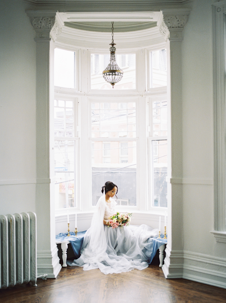 Bride sitting in a window at the Great Hall in downtown Toronto