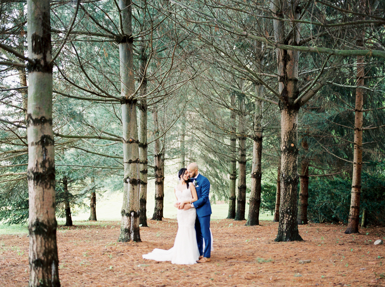 photo of bride and groom in the pine forest at kurtz orcahrds