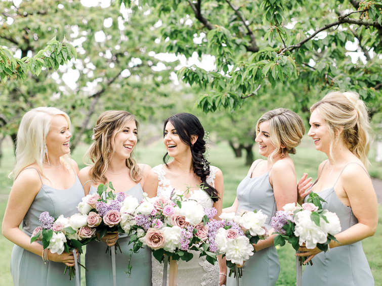 bride and her bridesmaids laughing at kurtz orchards