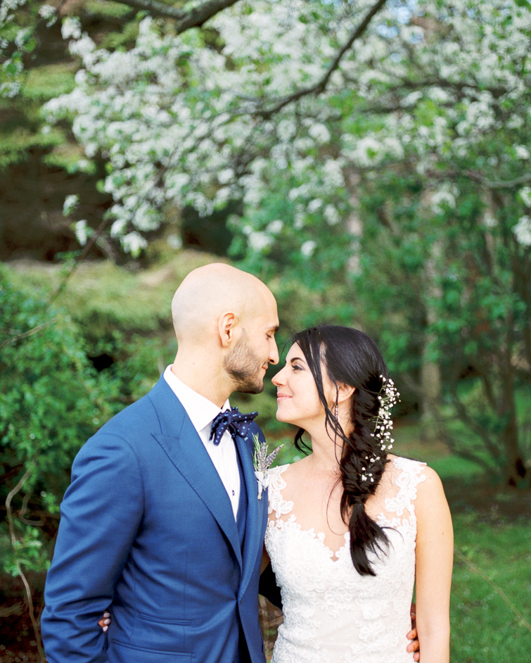 portrait of bride and groom under the cherry blossoms at kurtz orchard 