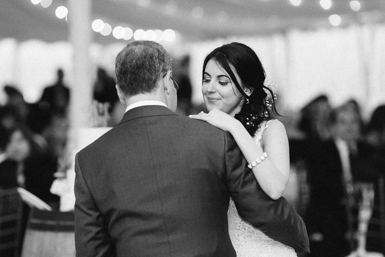 black and white image of bride dancing with her father