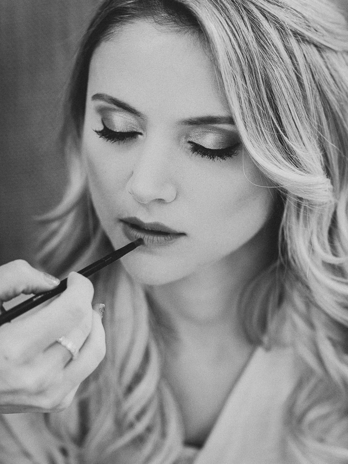 black and white portrait of a bride getting makeup done for her cambridge ontario wedding 