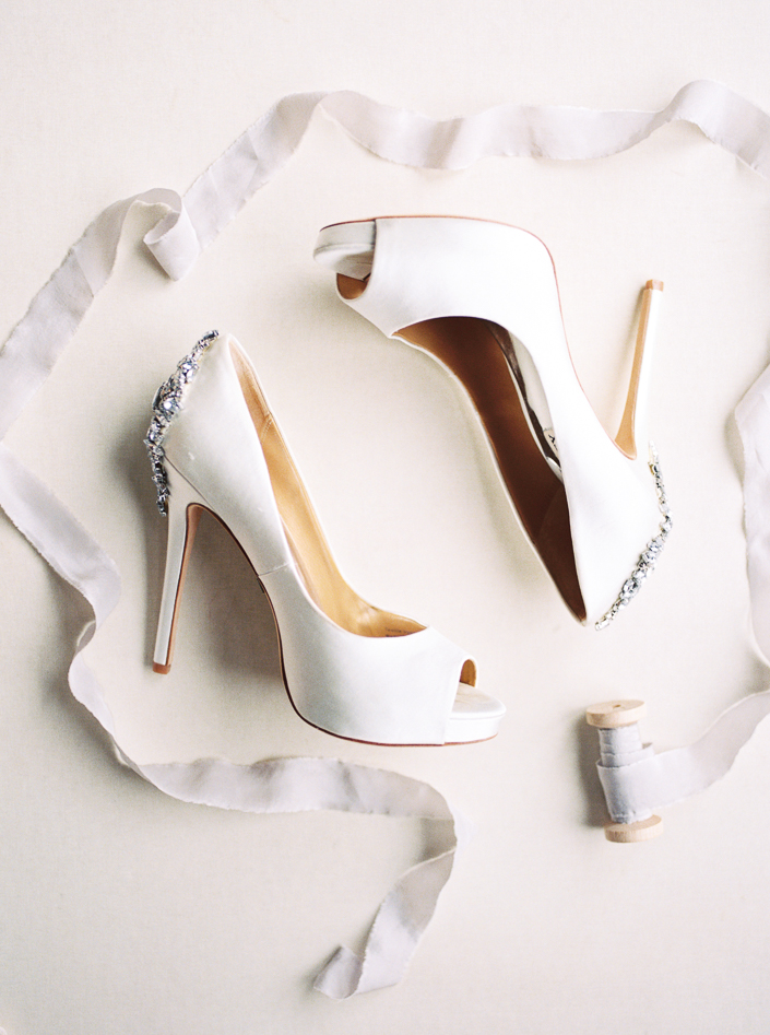 styled shot of white badgley mischka wedding shoes by Toronto wedding photographer Lushana Bale