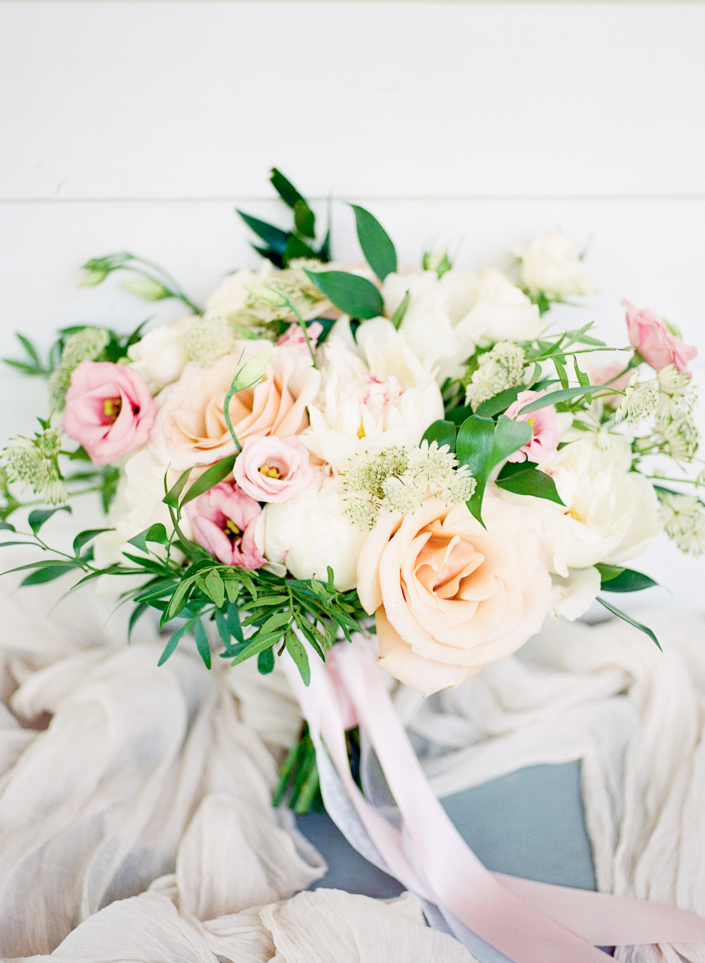  bridal bouquet with white, pastel and pastel garden roses and pops of greenery