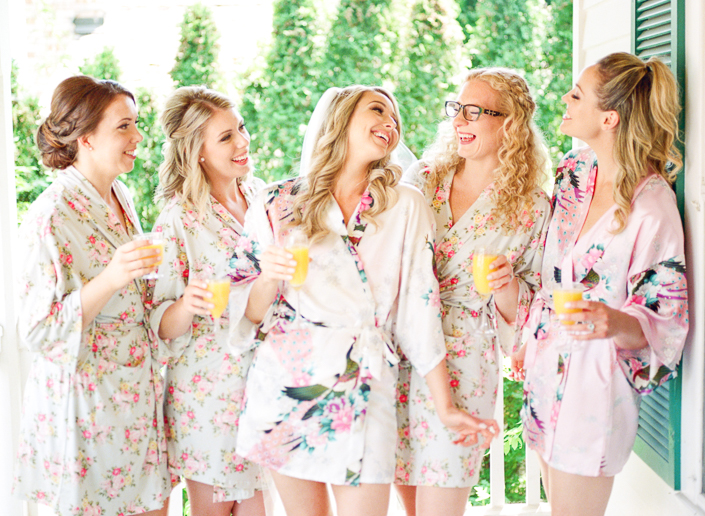 bride with her bridesmaids in robes drinking mimosas at the doctor's house bridal suite 