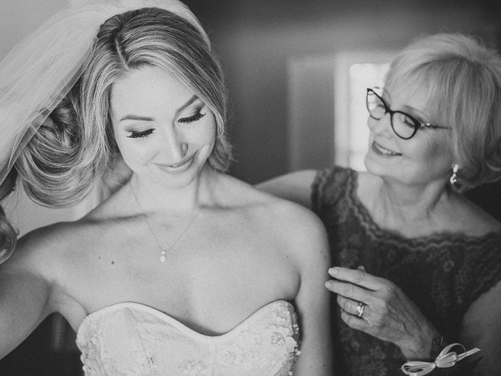 bride's mom helping her get ready